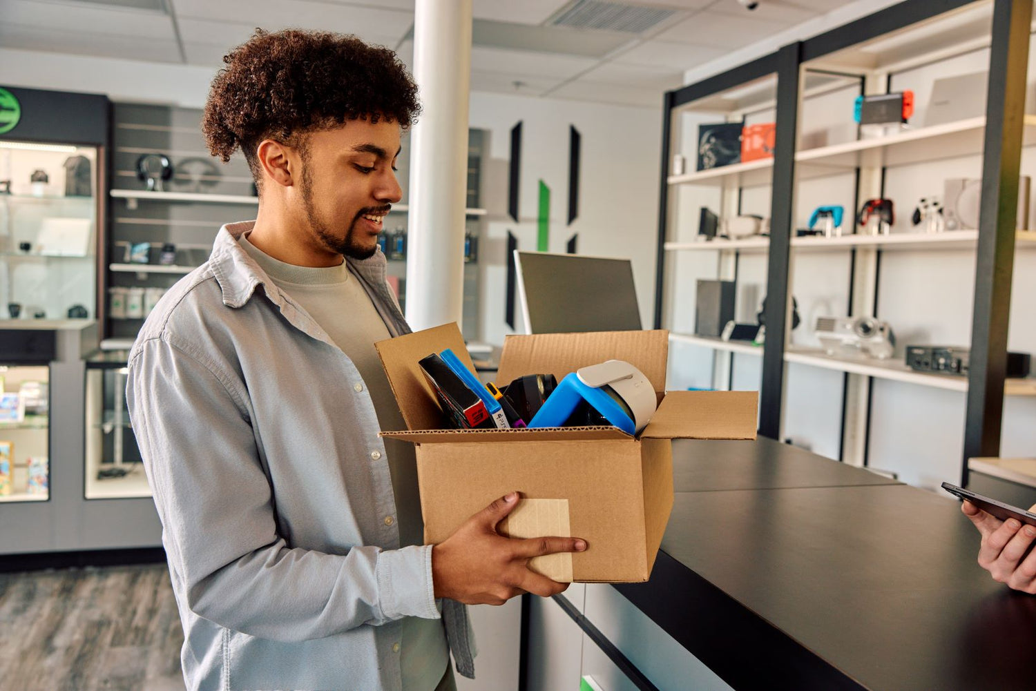man holding a box of electronics